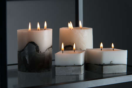 white candle on a concrete base.の写真素材