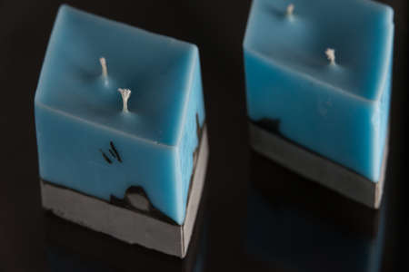 blue candle on a gray concrete base.の写真素材