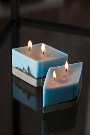 blue candle on a gray concrete base.の写真素材