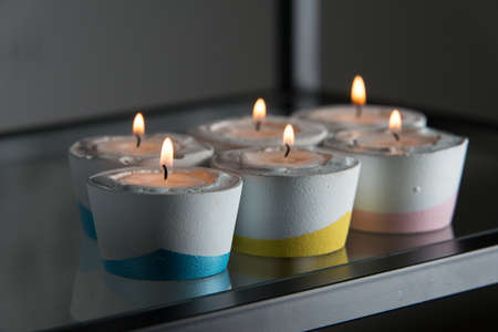candles in a differen colours concrete candle holders.の写真素材