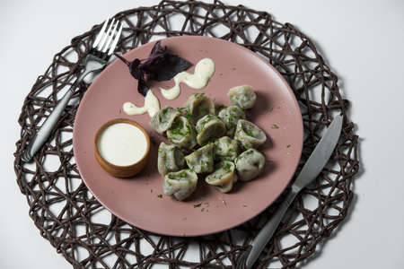 meat dumplings, homemade traditional Ukrainian dish pelmeni with sour creamの写真素材