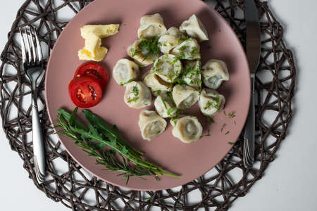 meat dumplings, homemade traditional Ukrainian dish pelmeni with sour creamの写真素材