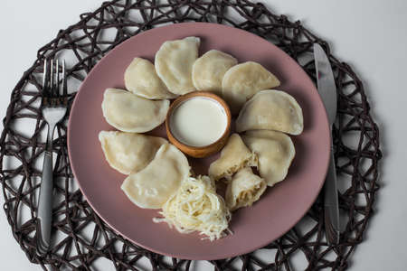 dumplings with stewed cabbage, homemade traditional Ukrainian dish varenyky with sour creamの写真素材