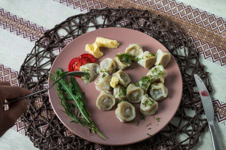 meat dumplings, homemade traditional Ukrainian dish pelmeni with sour creamの写真素材