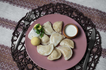 dumplings with potatoes, homemade traditional Ukrainian dish varenyky with sour creamの写真素材