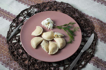 dumplings with cheese, homemade traditional Ukrainian dish varenyky with sour creamの写真素材