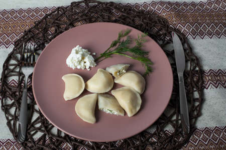 dumplings with cheese, homemade traditional Ukrainian dish varenyky with sour creamの写真素材