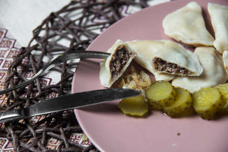 dumplings with pluck, homemade traditional Ukrainian dish varenyky with pickled cucumberの写真素材