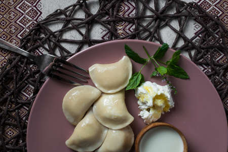 dumplings with cheese, homemade traditional Ukrainian dish varenyky with sour creamの写真素材
