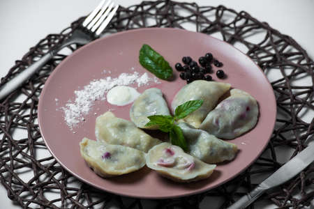dumplings with bilberry, homemade traditional Ukrainian dish varenyky.の写真素材