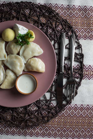 dumplings with potatoes, homemade traditional Ukrainian dish varenyky with sour creamの写真素材