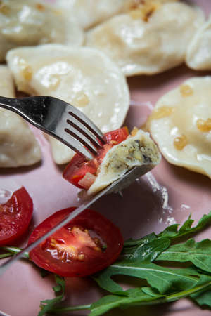 dumplings with potatoes and fried onion, homemade traditional Ukrainian dish varenyky with sour creamの写真素材