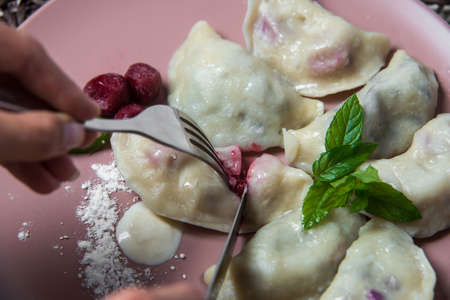dumplings with cherry, homemade traditional Ukrainian dish varenyky.の写真素材