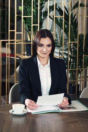 Portrait of a pretty young business lady working in a cafe.の写真素材