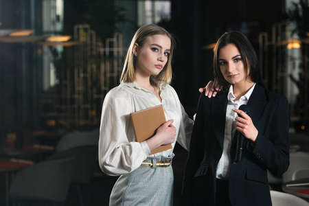 Business and speech topic: two women standing togetherの写真素材