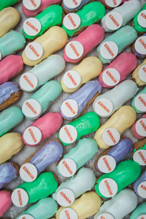 sweet and colorful eclair on glass. french eclair with word winner on top. hight angle view.の写真素材