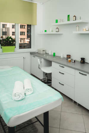 Interior of massage room in a clinic center. green shuttersの写真素材