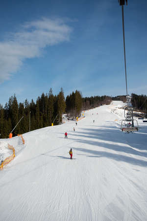 Empty ski-lift in the mountains. End of ski season, little snowの写真素材