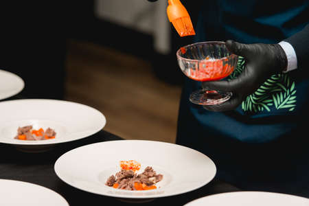 The chef in the restaurant preparing the dish. Traditional dish from Balkan cuisine - homemade lamb in a creamy sauceの写真素材