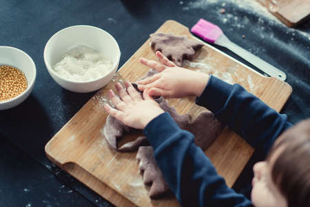 Close up of cookies baking. Little kids hands.