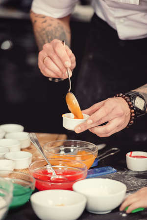 Close up of cookies baking. Mans hands.