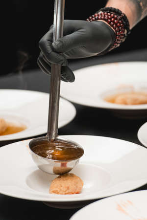 Chief making hungarian cuisine, dumplings with rabbit sauceの写真素材