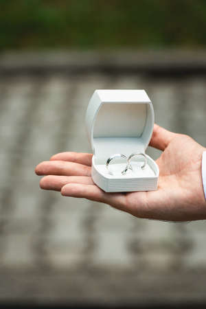 Box with a wedding ring in a hand at the manの写真素材
