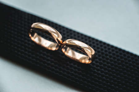 Close up of wedding rings on a black leather belt.の写真素材