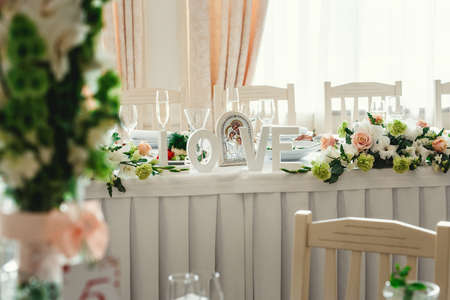 table at a wedding feast decorated with bridal bouquets. Word Love on a tableの写真素材