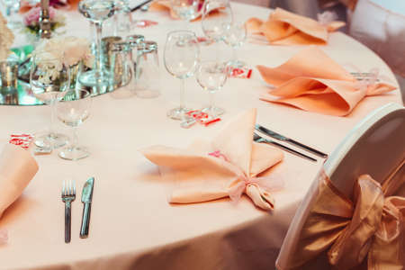 Simple and elegant wedding or festive table setting. beige and peach colorsの写真素材
