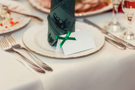 Served New Year or Christmas table closeup. Luxury restaurant. Green colours. One person