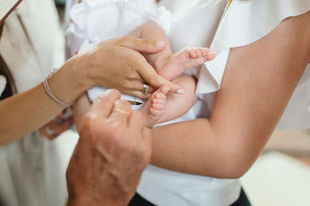 baptism ceremony in the church. priest performing a ritualの写真素材