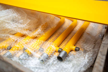 row of gas pipes. yellow gas pipes in plastic packing.の写真素材