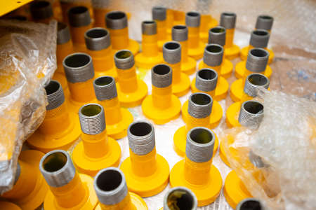 row of gas pipes. yellow gas pipes in plastic packing.の写真素材