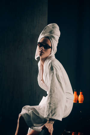 girl in a white towels, fashion portrait on a black background. Beauty retouchの写真素材