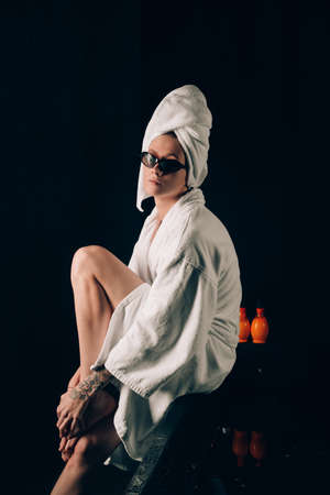 girl in a white towels, fashion portrait on a black background. Beauty retouchの写真素材