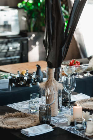 Served tables for wedding banquet with plates restaurant. Decor from fresh flowers, coconuts and dark leafsの写真素材