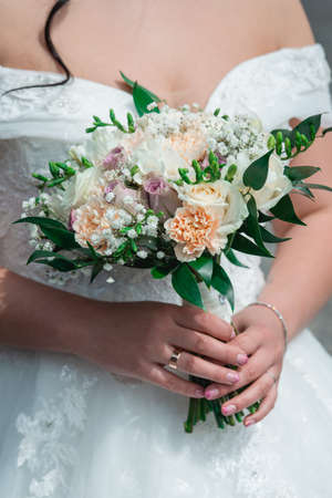 Beautiful wedding bouquet in hands of the brideの写真素材