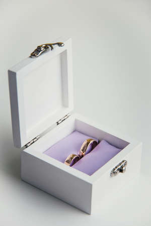 Wedding rings in white wooden gift boxの写真素材