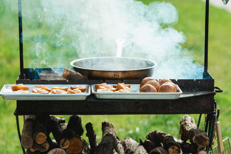 Beef and Pork Patty for Burger. Cooking Cutlets on Mangal. Grill Minced Meat. Chef Cooks burger in street outdoors. Summer Picnic in Nature. Tasty Meat Dish. Closeupの写真素材
