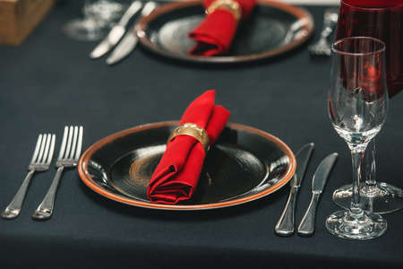 Table served for Christmas dinner in red colors in a restaurant, close up viewの写真素材