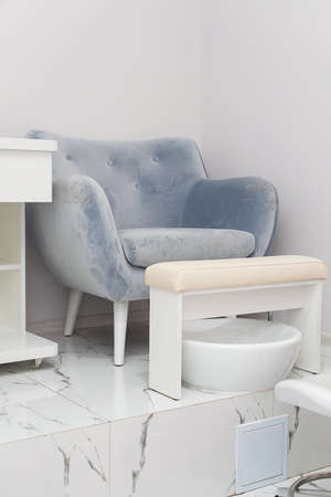 Interior of white modern manicure salon without people. Luxury work places for masters of pedicureの写真素材