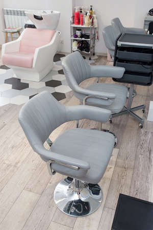 Workplace for haircut in barbershop, with backlit mirror. stylish chairsの写真素材