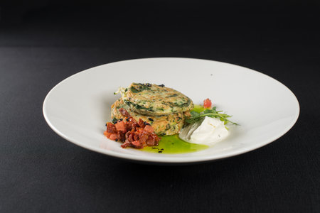 Zucchini pancakes served with sun-dried tomatoes and cream cheeseの写真素材