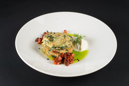 Zucchini pancakes served with sun-dried tomatoes and cream cheeseの写真素材