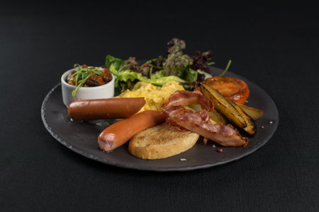 Traditional English breakfast. Sausage, beans, eggs, bread and saladの写真素材