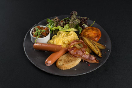Traditional English breakfast. Sausage, beans, eggs, bread and saladの写真素材