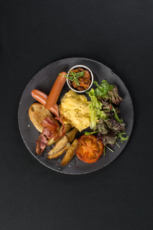 Traditional English breakfast. Sausage, beans, eggs, bread and saladの写真素材