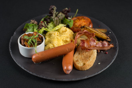 Traditional English breakfast. Sausage, beans, eggs, bread and saladの写真素材