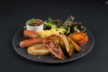 Traditional English breakfast. Sausage, beans, eggs, bread and saladの写真素材